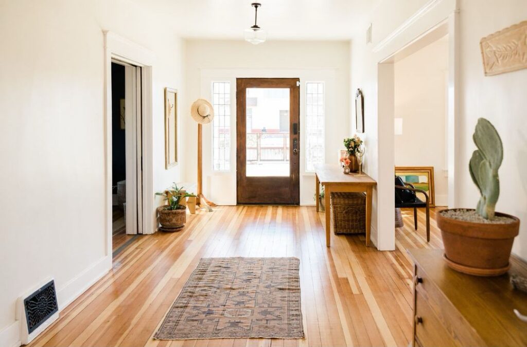 Estate & Life Transition Support represented by a bright home entryway symbolizing downsizing, relocation, and new beginnings.